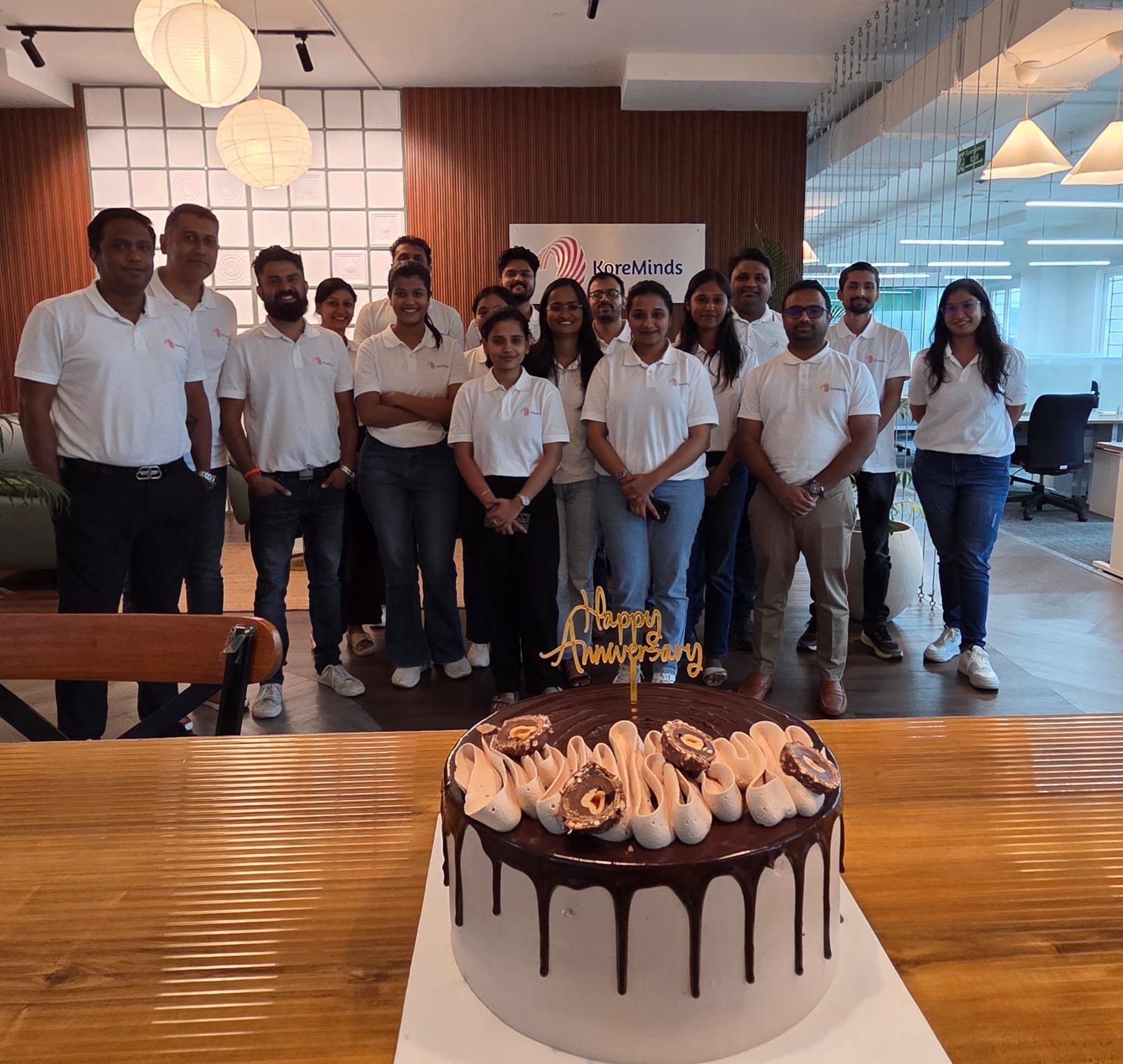 KoreMinds team with the anniversary cake
